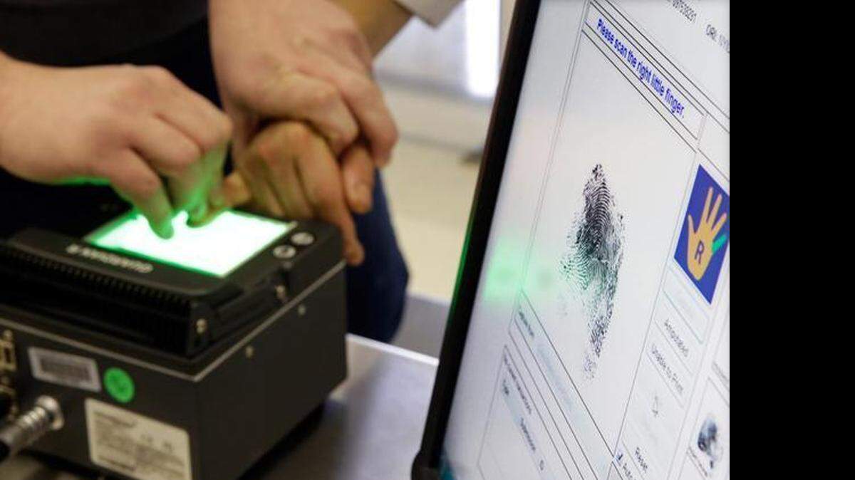
Authorities take fingerprints following a migrant entry on the U.S.-Mexico border. 
