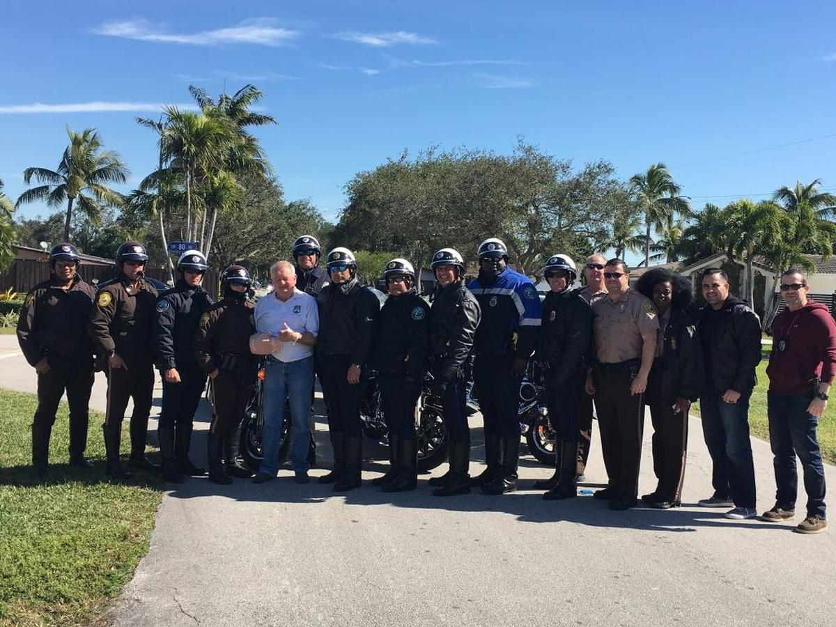 Lt. Gary King is surrounded Thursday by his fellow Doral police officers after being shot in his driveway at his Palmetto Bay home Tuesday night in an attempted armed robbery.