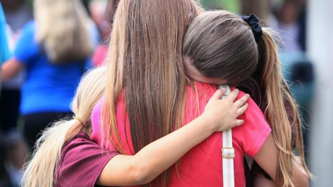 A mother is embraced by her two daughters during a walk and remembrance in a show of solidarity with the victims of the Parkland school shooting on Saturday. The walk started at North Community Park in Coral Springs and ended at Marjory Stoneman Douglas High School in Parkland. A Broward County judge on Monday agreed to release security video of the assault on Marjory Stoneman Douglas High School on Thursday, barring an appeal.
