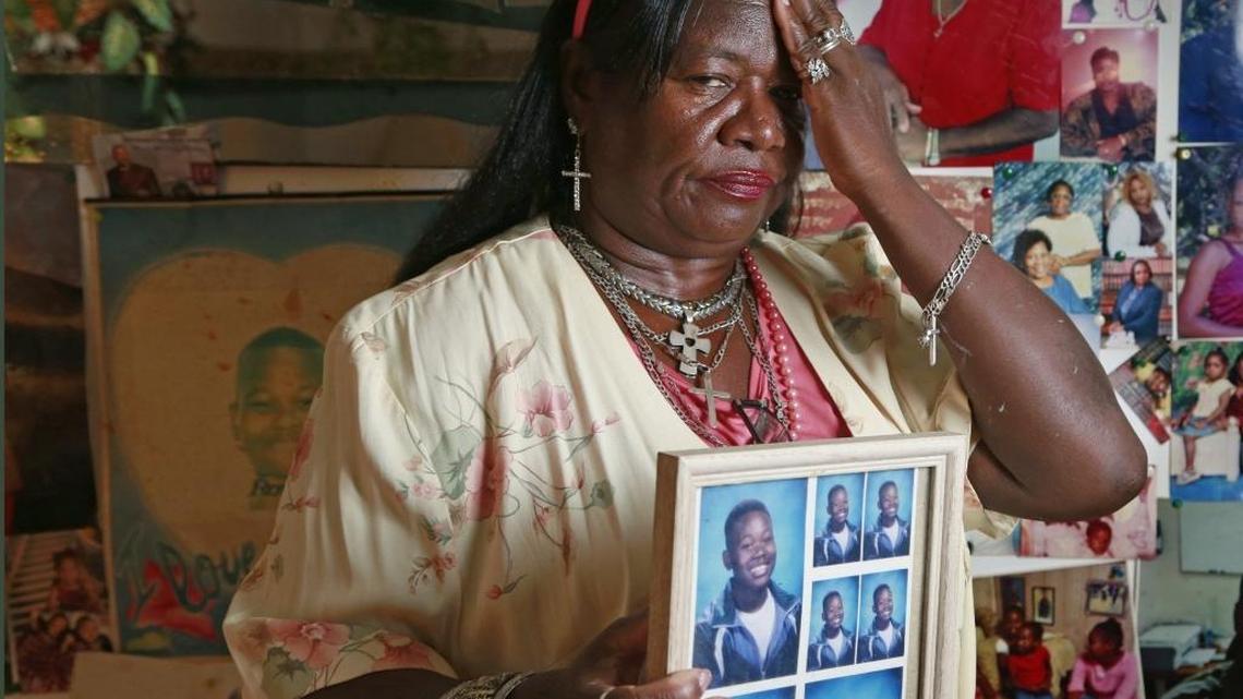 Della Wright with a portrait of her son Jerome Wright, as a young boy, at her home in Miami.