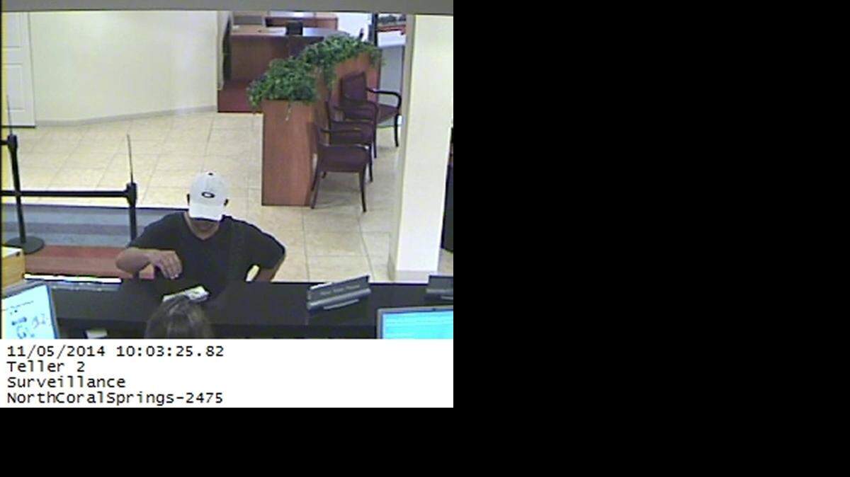 
Video surveillance shows a man demand money at a BB&T bank branch at 4695 University Drive around 10 a.m. Wednesday.
