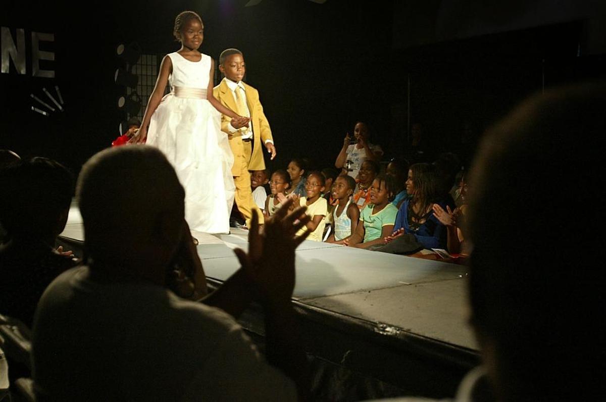 Sheba Callaway (left) and an 8-year-old Juwan Downes (right) take part in the Foundation of Community Assistance and Leadership (FOCAL) fashion show at Moore Park Learning Center in November 2006