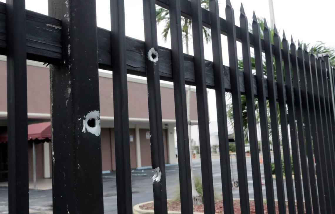 Bullet holes in a fence across the street where six Hialeah police officers fired on Lester J. Machado at Northwest 35th Avenue and 79th Street in Miami.