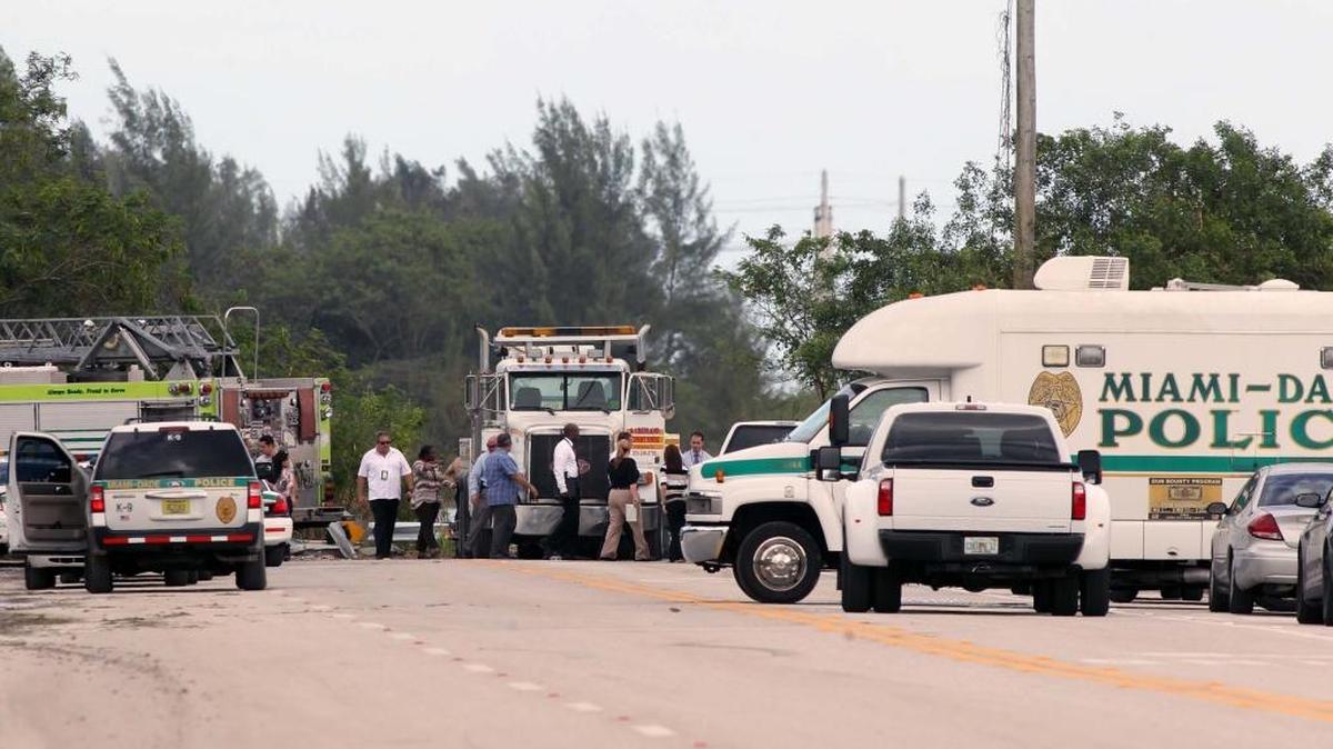 Miami-Dade police work the scene of a submerged car on Thursday.