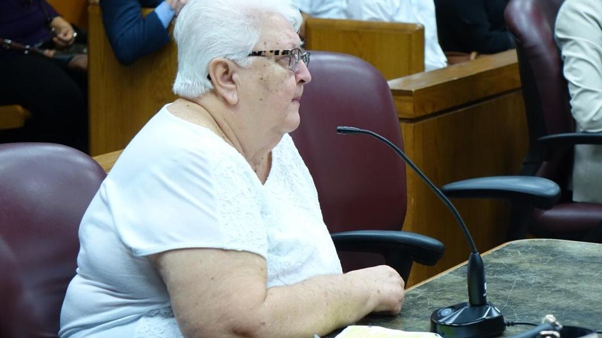 Gladys Coego, convicted of voter fraud, listens as relatives talk about her in Miami-Dade court. She was sentenced to two years of house arrest.