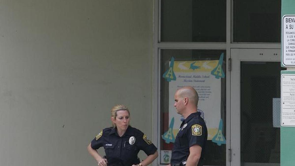 Two teens at Homestead Middle school were arrested Tuesday after officers found them with a gun. This file photo shows school police outside the school in 2006.