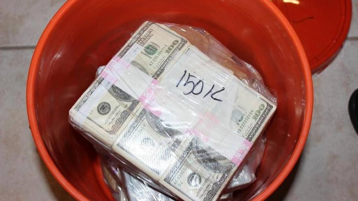 The bucket with the bills from a Miami-Dade bust.