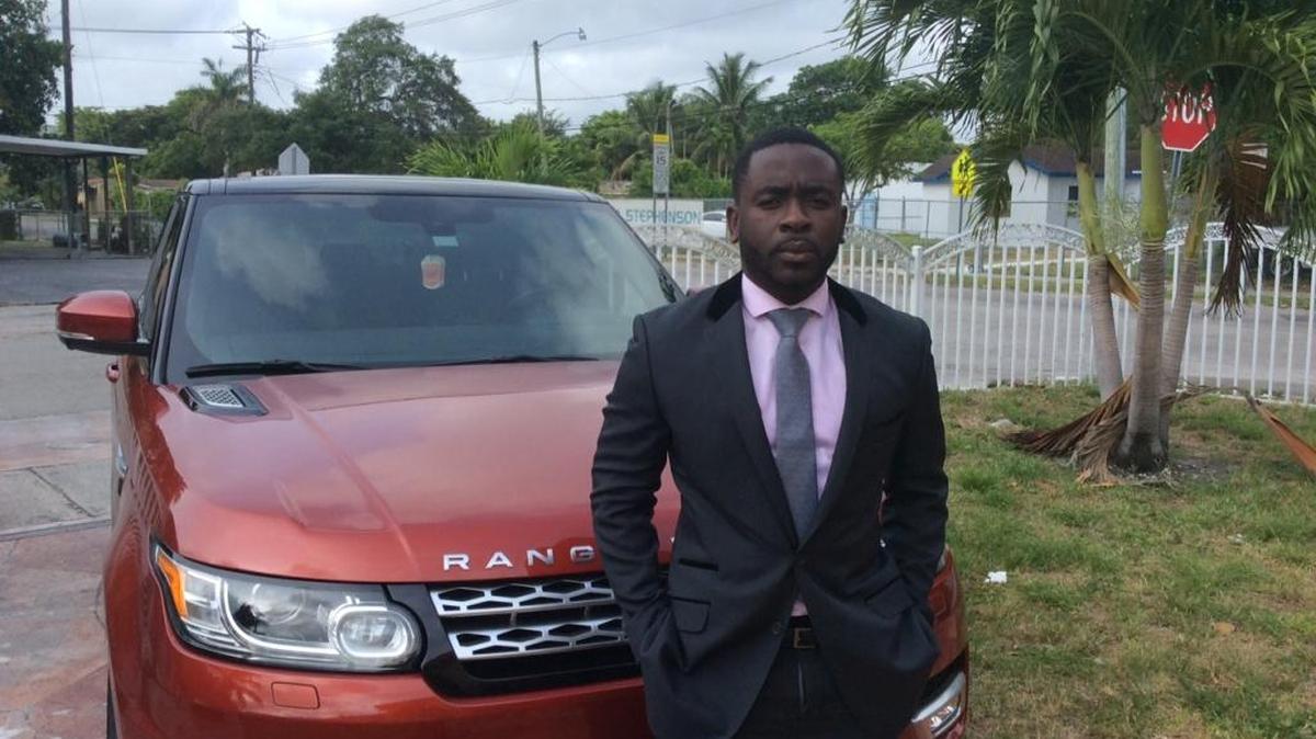 Sniders Jean-Jacques in front of his Range Rover outside of his North Miami Beach home. Jean-Jacques said he was tossed from Neiman Marcus because of his skin color.