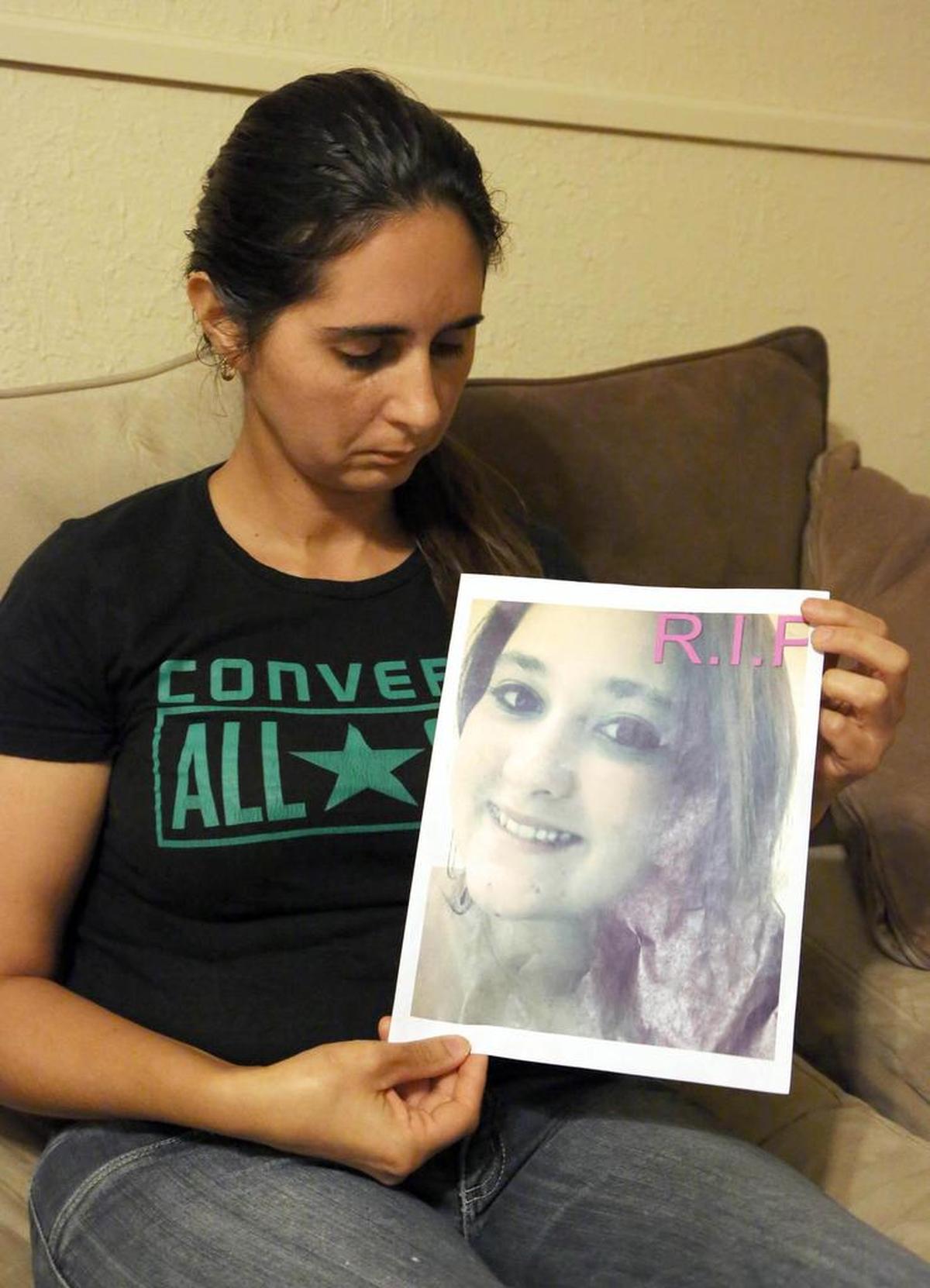 Andrea Perez holds a photo of her daughter, Romina Fernandez, who was found murdered and burned in a Sweetwater dumpster in 2014.