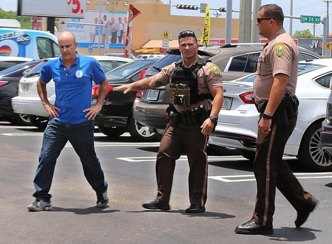 Osmani Hernandez, left, reacts after finding out his wife was one of the victims of a shooting at the Latin Cafeteria Restaurant at 7360 SW 24th St. on May 20, 2017.