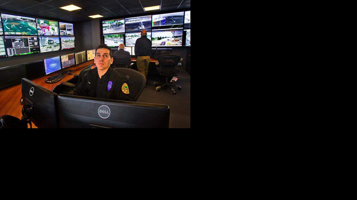 
Miami Police Officer Alejandro Gutierrez works in the department's new high-tech central command post, which was unveiled on Wednesday January 14, 2015. The command post consists of dozens of new high resolution televisions hooked up to cameras all over the city.
