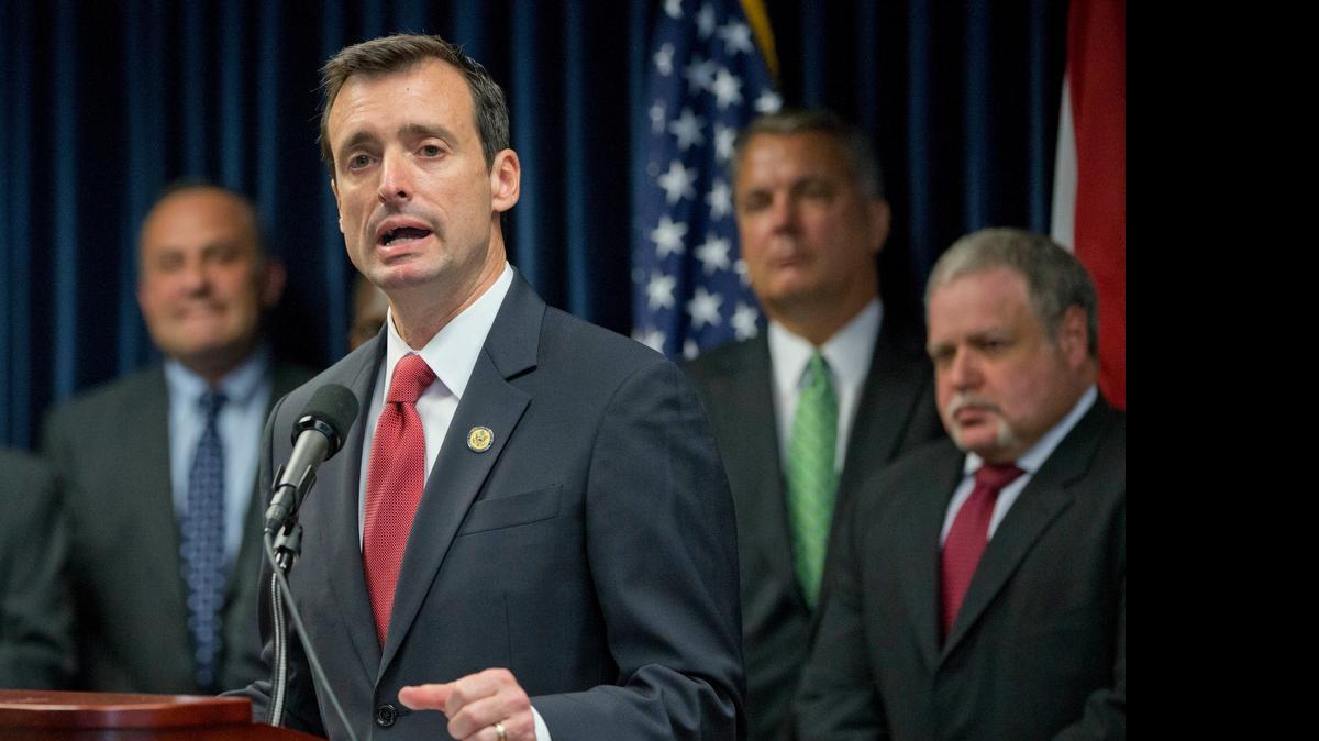 
U.S. Attorney for the Southern District of Florida, Wifredo Ferrer, foreground, gestures as he speaks during a news conference announcing the results of an operation by the South Florida Identity Theft Tax Fraud Strike Force, against identity theft refund schemes, Thursday, April 9, 2015, in Miami. Federal investigators say 42 people in South Florida have been charged with identity theft and fraud that involved intended losses of $21 million. 
