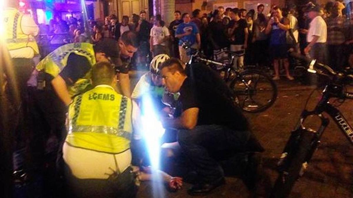 
Emergency medical workers and police work next to a person at the scene of shooting on Saturday night in Fort Myers. One person as killed and four were wounded.
