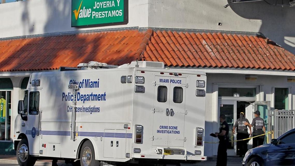 Miami police investigate the scene of a robbery and shooting death of a customer at the Value Joyeria y Prestamos store on Southwest 17th Avenue on Thursday, January 5, 2017.