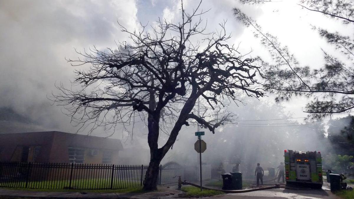 
Miami-Dade Fire Rescue fight a fire set purposely by a man who barricaded and killed himself inside the burning home at the 2400 block of NW 42nd Street, Friday, Aug. 7, 2015.
