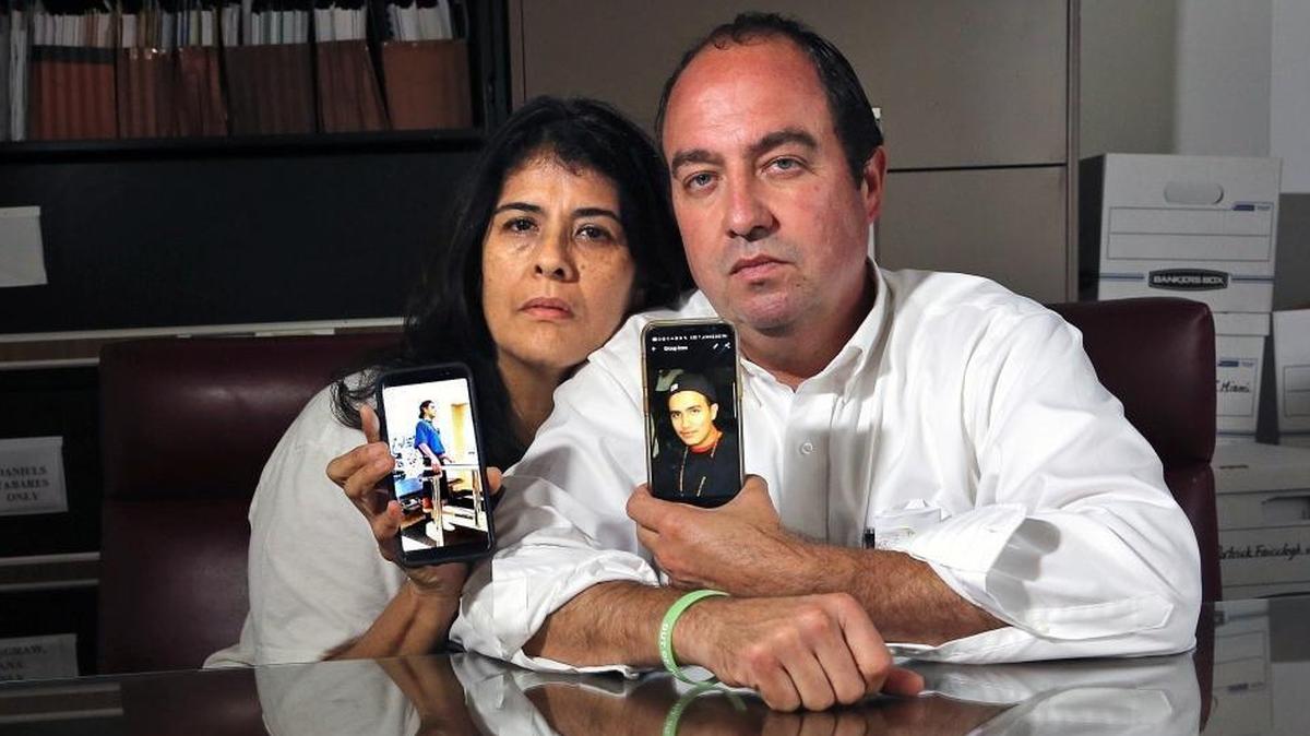 Amalia Villafane-Gregory and Andres Gregory hold photos of their son Sebastian, who had been shot six times by a Miami-Dade police officer in 2012 and committed suicide in 2016. They are suing the county over what they argue was excessive use of force by the officer.