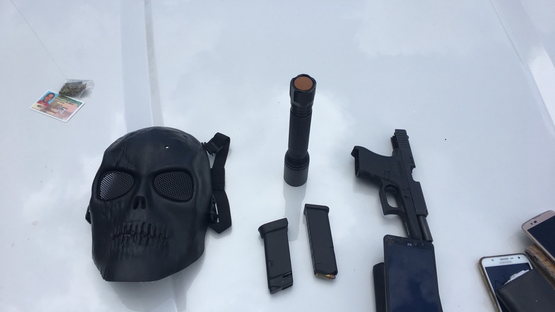 A black mask, stolen Glock handgun, a black mask, a flash light, and marijuana were found in the silver Nissan Altima that police followed to the Walmart.