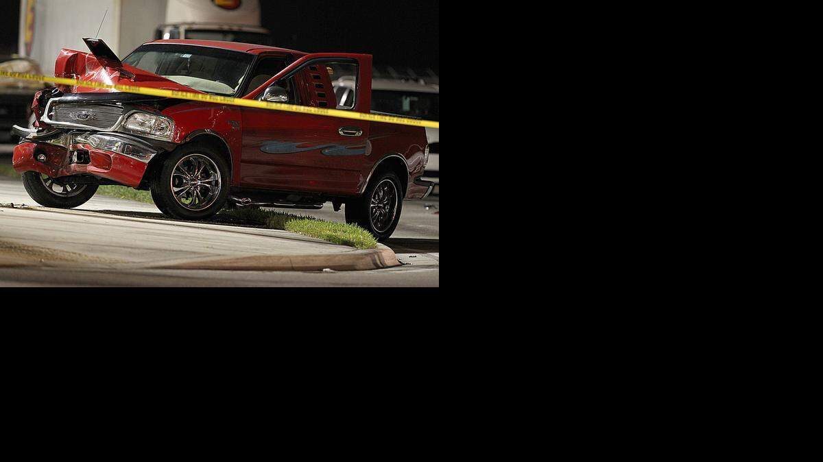 
A woman crashed this Ford truck against a light pole after her ex-husband chased her in his own pickup truck and shot at her, forcing her off the road at 13600 SW 137th Ave. in Kendall on Tuesday, Nov. 18, 2014. The man later shot and killed himself.
