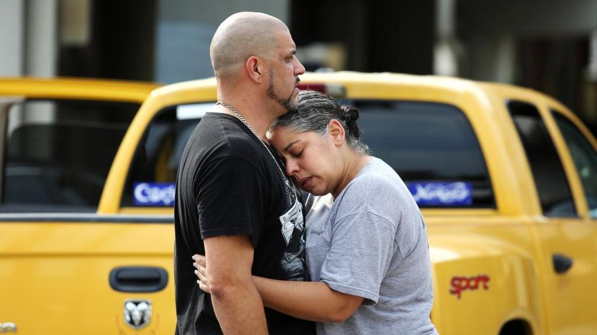 Ray Rivera, a DJ at Pulse Orlando nightclub, is consoled by a friend, outside of the Orlando Police Department after a shooting involving multiple fatalities at the nightclub, Sunday, June 12, 2016.