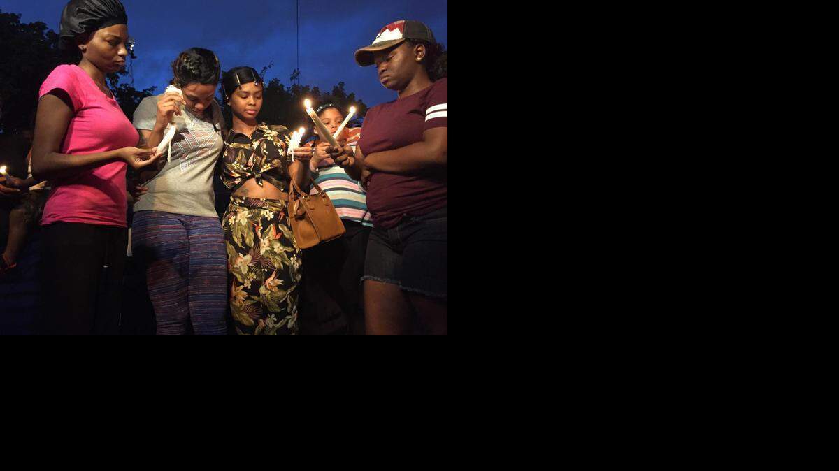
Elizabeth Ruffin (center in gray top), the mother of Marlon Eason, the 10-year-old boy who was shot to death in front of his home Tuesday night, was surrounded by friends and family Wednesday night.
