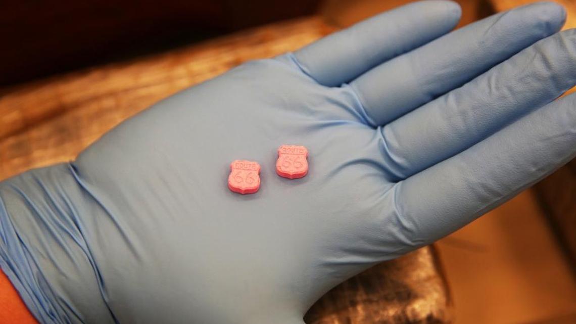 U.S. Customs and Border Protection officers show Molly pills that were logged into then released from evidence at their secret facility in Miami-Dade County. There is an imprint of Route 66 on them.
