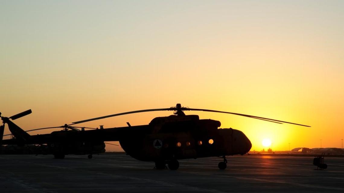 The sun sets over Afghan air force Mi-17 helicopters at Kandahar Airfield, Kandahar, Afghanistan, Oct. 25, 2011.
