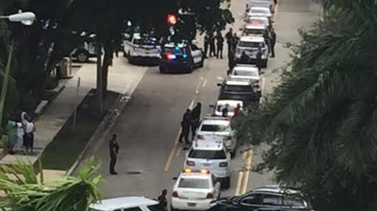 Police swarm the Brickell area on Tuesday morning to detain two people of interest in the shooting death of a New York tourist in South Beach.