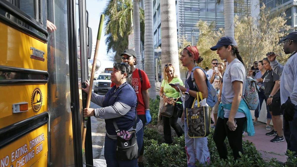 Miami Beach city employees getting on the bus to help to clear the streets and parks of debris and trees in the Hurricane Irma aftermath on Wednesday, Sept. 13, 2017.