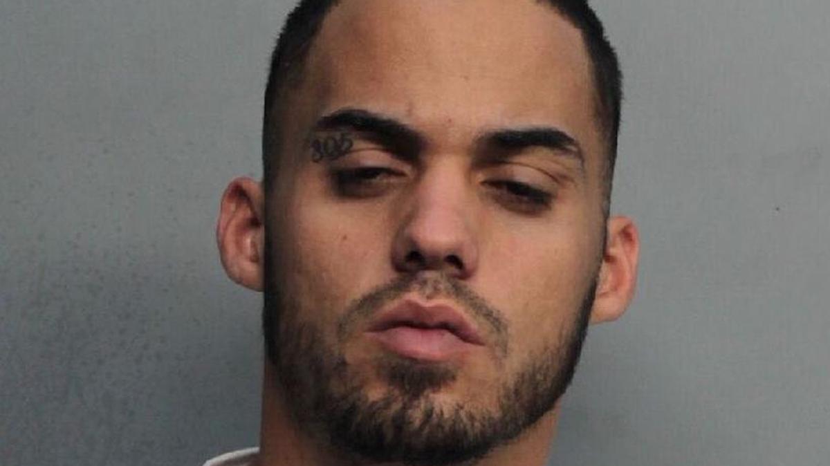 Alex Romero, an ex-con with 305 tattooed on his eyelid, is challenging a state law that makes it illegal to threaten law officers.