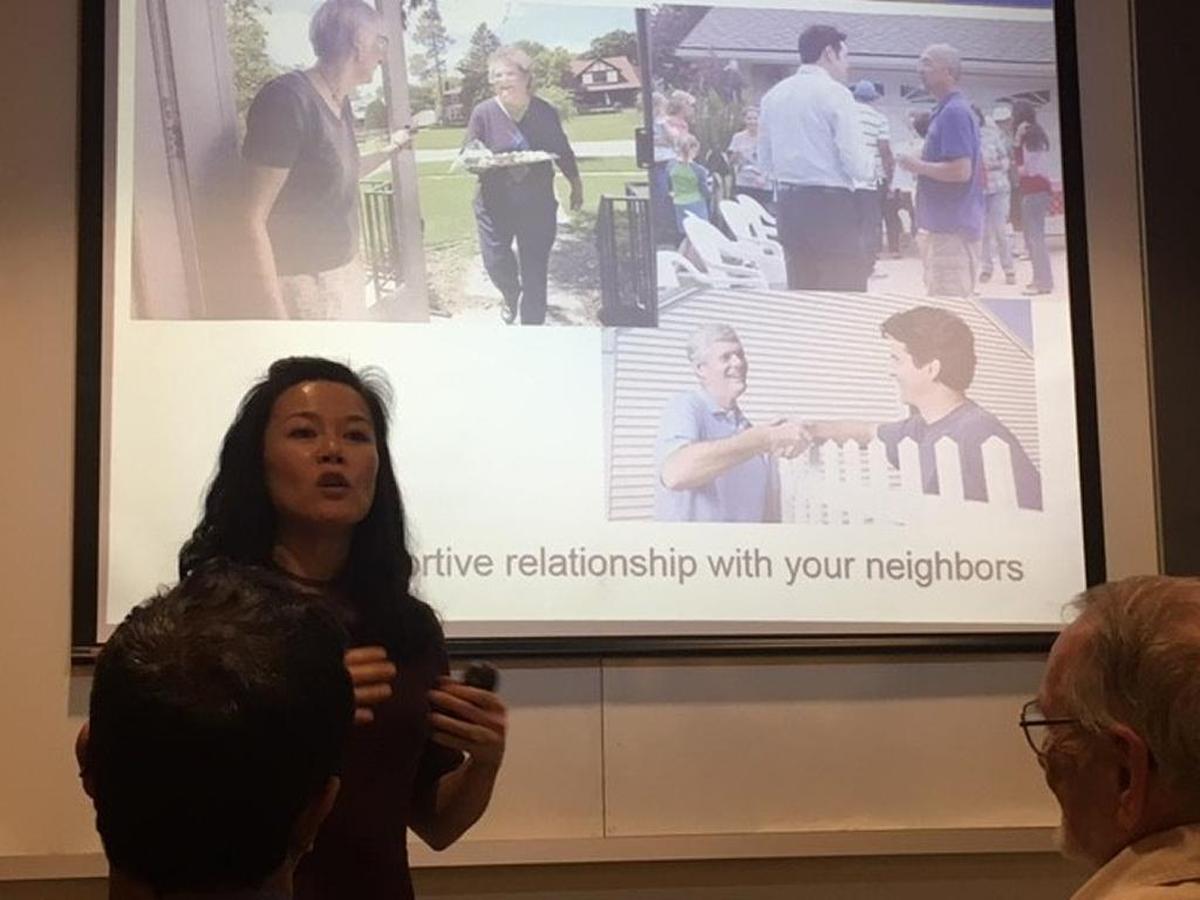San Jose Crime Watch coordinator Mini Lee speaks at a recent California neighborhood meeting attended by Carmen Caldwell.