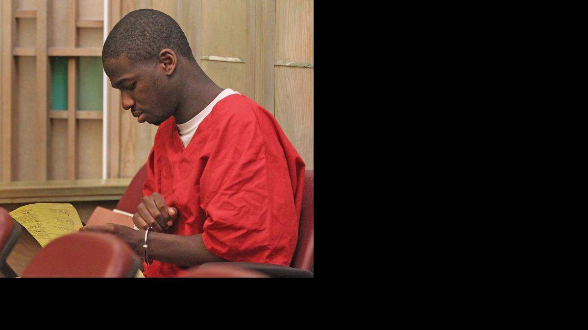
Miami cop killer Andrew Rolle, 27, shows no emotion and barely pays attention Monday as he flips through his legal pad as Judge Marisa Tinkler Mendez sentended him to life in prison for the first degree murder of City of Miami detective James Walker.
