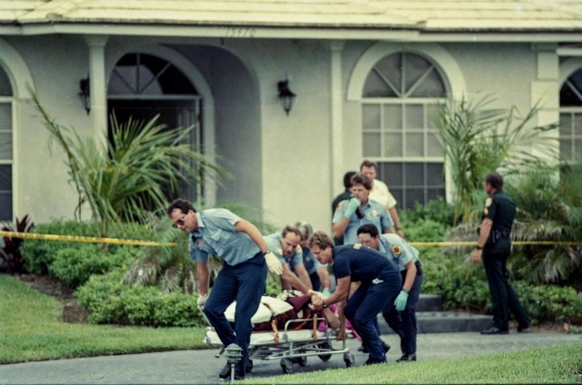 Paramedics take Marlene Warren, 40, to an ambulance on Saturday, May 26, 1990, after she was shot in front of her home in Wellington, Fla. She died two days later.
