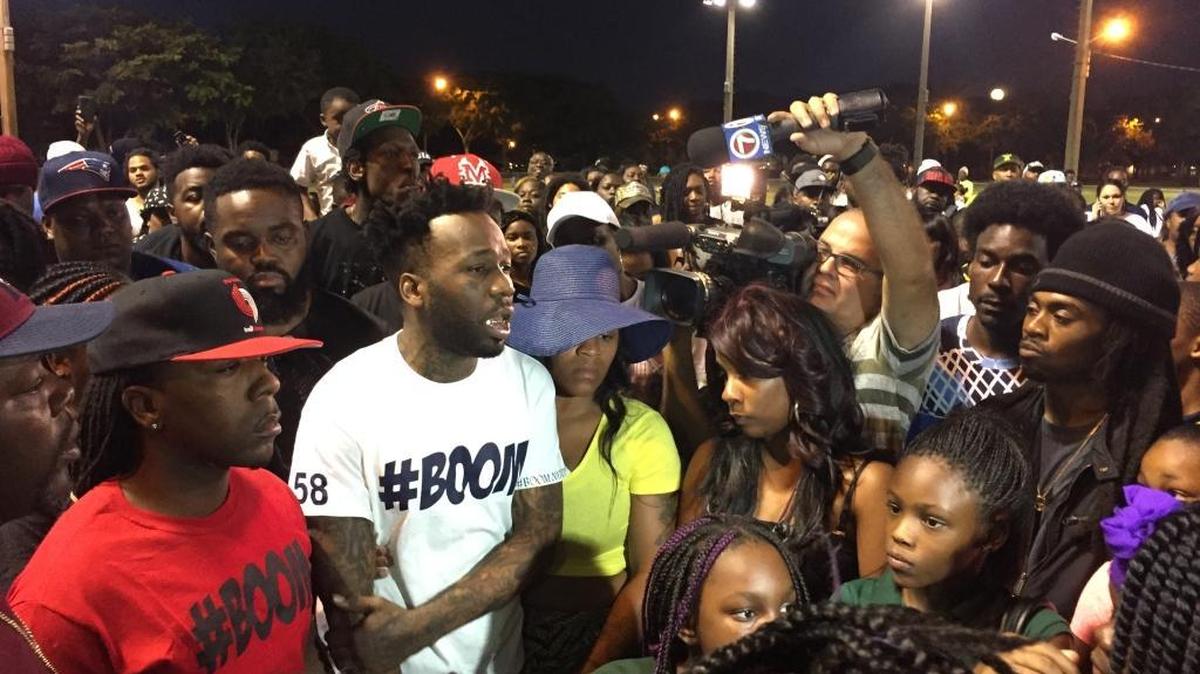 King Carter’s dad, Santonio Carter, center in white, addresses about 200 people who marched in memory of the 6-year old Monday night in Charles Hadley Park in Liberty City.