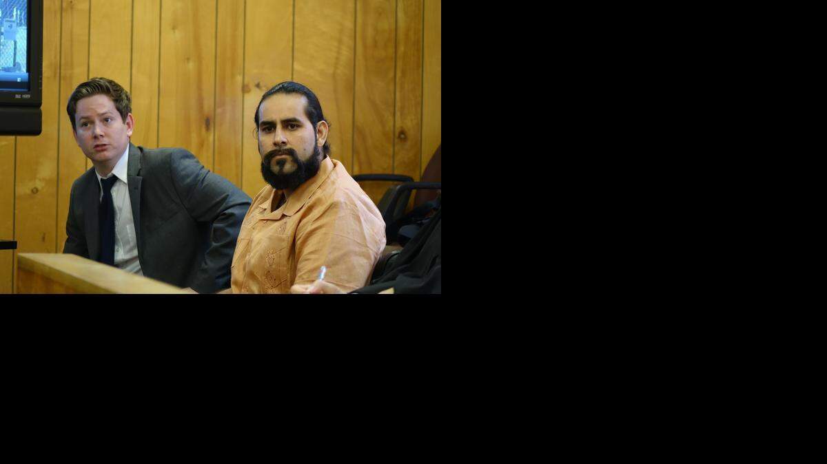 
Christian Minaya (right), accused of criminal mischief during a protest at a West Miami-Dade primate research import facility, on trial flanked by his lawyer, Patrick Wilson.
