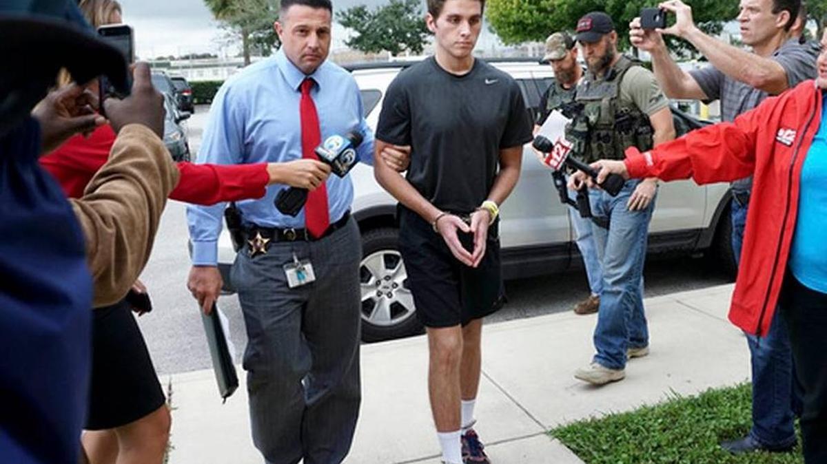 FILE - In this Monday, Oct. 3, 2016, file photo, Austin Harrouff is transported by detectives to the Martin County Jail from St. Mary's Hospital in Florida. Harrouff, the Florida college student accused of randomly killing a couple and chewing on the dead man's face, told TV personality Phil McGraw he had been running from a demon-like figure named Daniel before the attack. In a video released Tuesday, Feb. 28, 2017, by prosecutors, Harrouff told McGraw he only had vague memories of killing John Stevens and Michelle Mishcon last Aug. 15