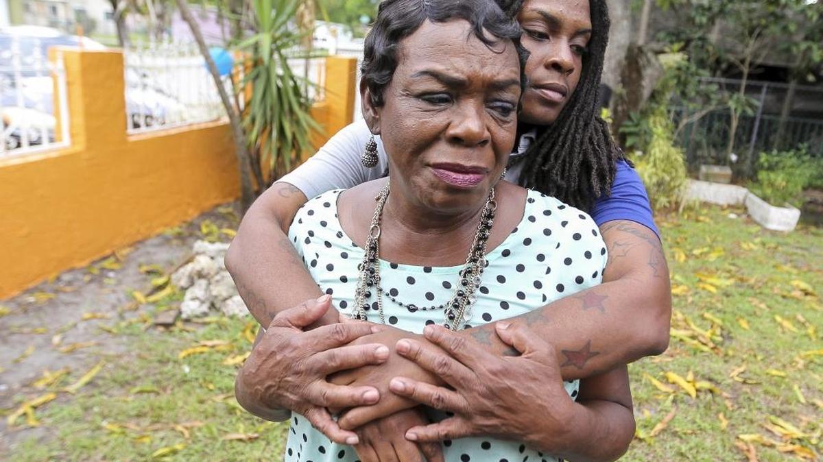 Bianca West holds her grandmother, Mae West. The family is recoverign after a wake for family member Devonair Blake was interrupted by gunfire that struck four people and took two lives early Saturday morning.