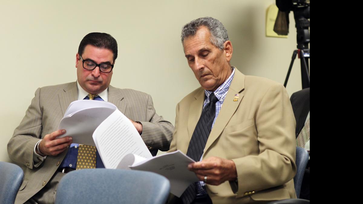 
Convicted Ponzi schemer Luis Felipe Perez, left, and former Hialeah Mayor Julio Martinez during an ethics hearing into statements that current Hialeah Mayor Carlos Hernandez made about his high-interest loans to Perez. The ethics panel fined Hernandez $3,000.
