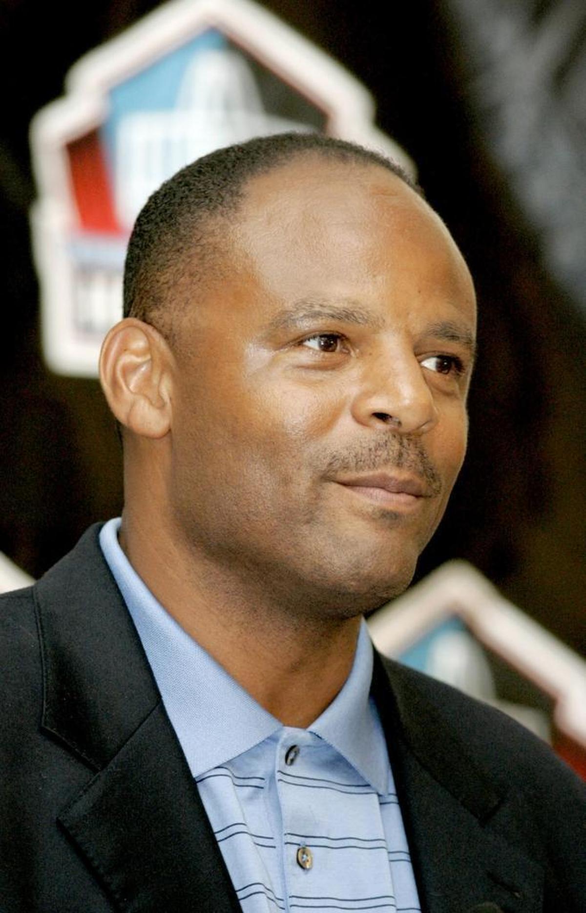 Former NFL quarterback Warren Moon during a Hall of Fame press conference in 2013. His firm was ripped off of $200,000 by a conman named George French Jones, whom police say has struck again in Miami.