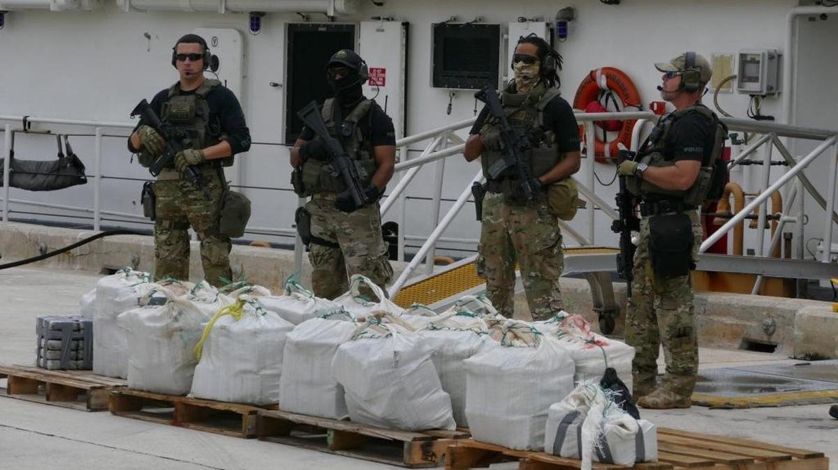 Authorities guard a shipment of cocaine.