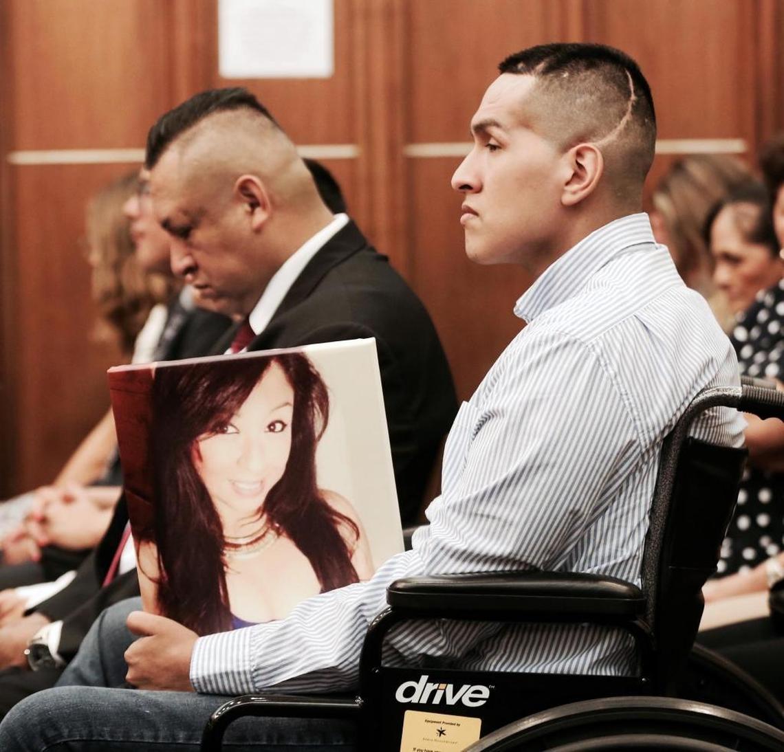 Bryan Criales, now confined to a wheelchair, holds a photo of his deceased sister Carmen Criales, who was killed in a car accident involving Franklin Chavez. Chavez was driving the wrong way on I-95.