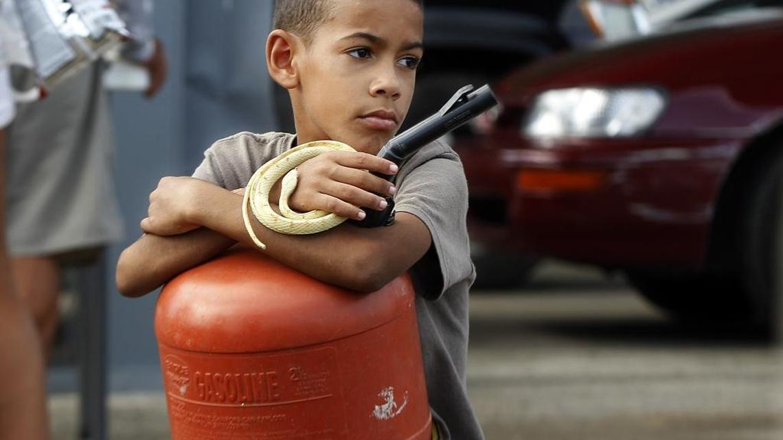 Francisco Martinez, 9, a student at the public school Jose Facundo Cintron, waits in line Sunday to get gasoline with his family in the town of Yabucoa after Hurricane Maria passed through Puerto Rico on September 20.