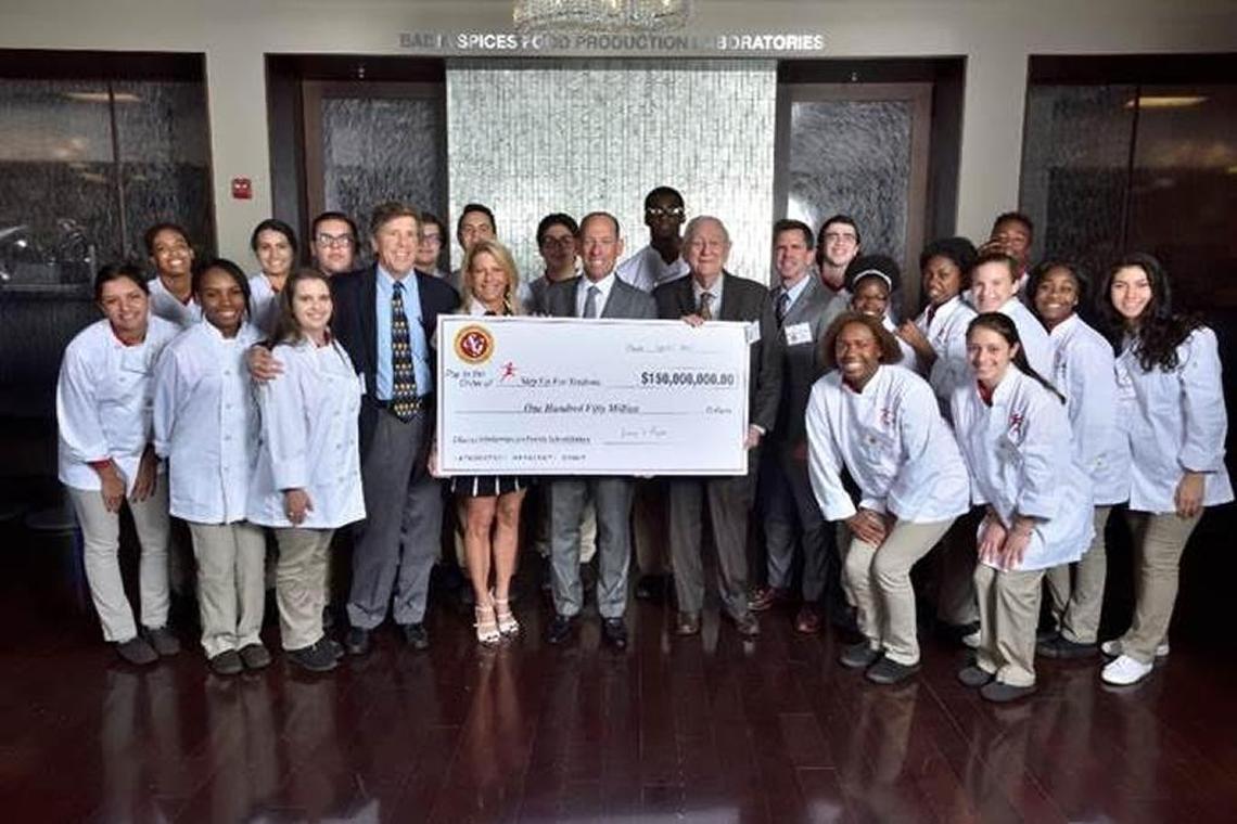 Southern Glazer’s Wine & Spirits announced in 2017 that it will donate $150 million to the Step Up For Students Scholarship Program in Miami. Chairman Harvey Chaplin is holding the check to the right in this 2017 file photo.