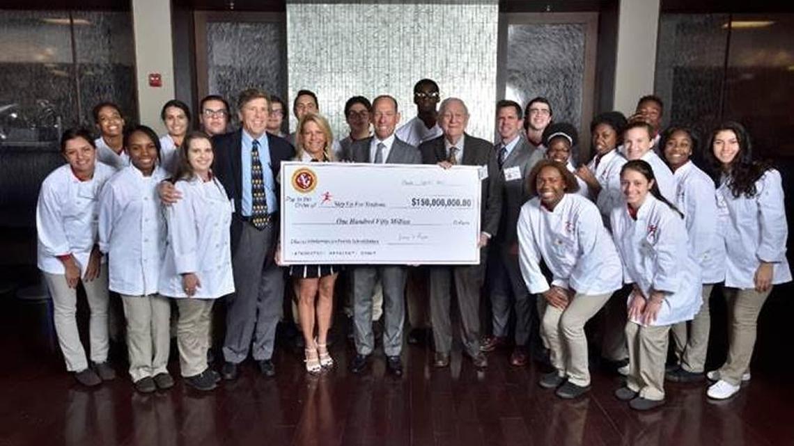 Southern Glazer’s Wine & Spirits announced in 2017 that it will donate $150 million to the Step Up For Students Scholarship Program in Miami. Chairman Harvey Chaplin is holding the check to the right in this 2017 file photo.
