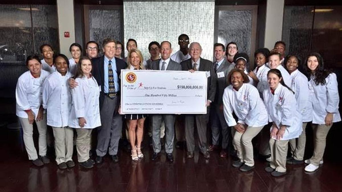 Southern Glazer’s Wine & Spirits announced in 2017 that it will donate $150 million to the Step Up For Students Scholarship Program in Miami. Chairman Harvey Chaplin is holding the check to the right in this 2017 file photo.