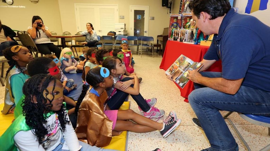 Ed Boland Jr (right), co-founder of The HeroBoys comics, reading to a group of children at the Miami Lighthouse for the Blind and Visually Impaired on Wednesday, June 28, 2017. The HeroBoys, subjects of a new line of comic books and toys, visited the Miami Lighthouse to celebrate adventure, imagination, and limitless potential with blind children.