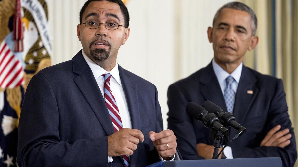 U.S. Education Secretary John B. King Jr., accompanied by President Barack Obama, speaks in the State Dining Room of the White House in October 2015. (AP Photo/Andrew Harnik, File)