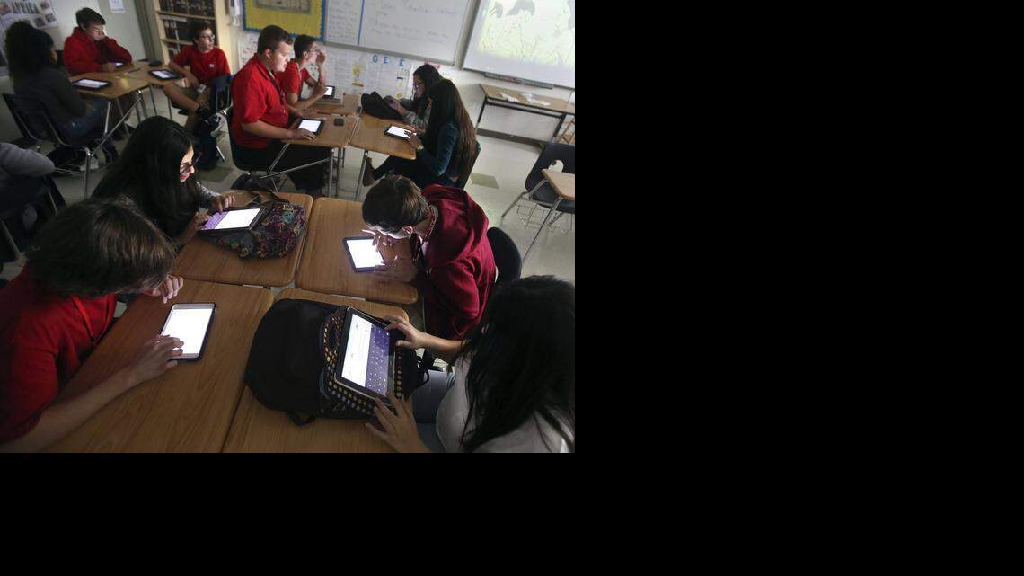 
Miami Beach Senior High ninth graders work by the glow of electronic tablets in Nadia Zananiri's World History class on Friday, Nov. 7, 2014. 

