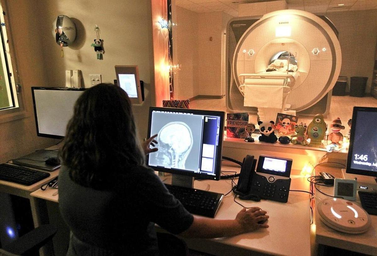 Professor Angie Laird, director of the Center for Imaging Studies studies an MRI scan at Florida International University. FIU is taking part of a nationwide 10-year study involving brain scans of children.