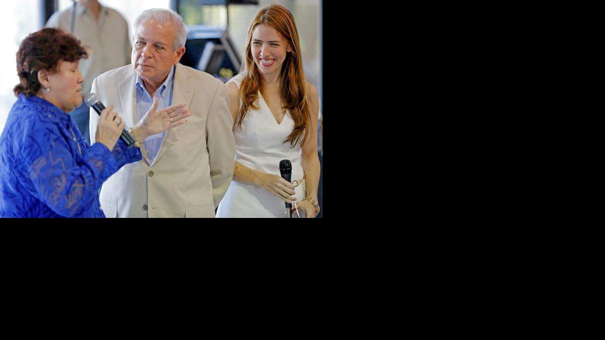 
Raquel Regalado, right, and her father, Miami Mayor Tomas Pedro Regalado at the Myers Senior Center as Marta Gonzalez speaks during an early celebration of Thanksgiving in Miami.
