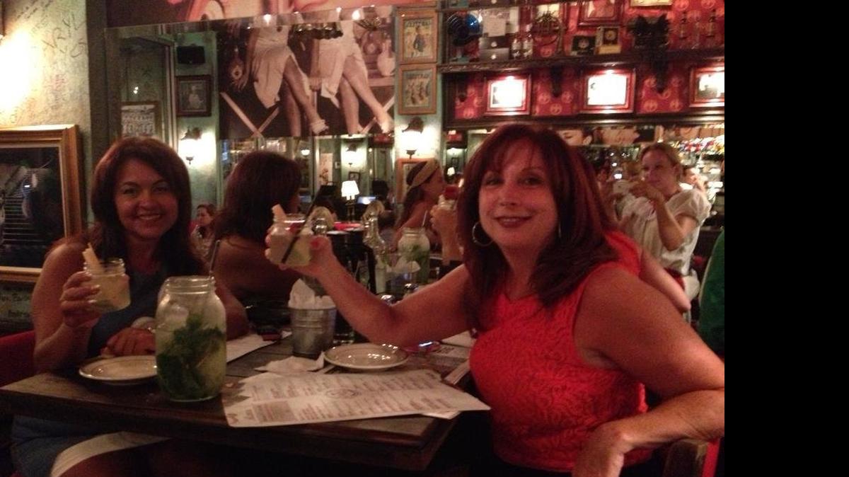 
CIE employee Marybell Serrano and school owner Karyn Vidal toast mojitos together at Havana 1957 on Lincoln Road in this 2013 Facebook photo. The two women were recently accused of falsifying records, but a CIE investigation found no evidence of wrongdoing. 
